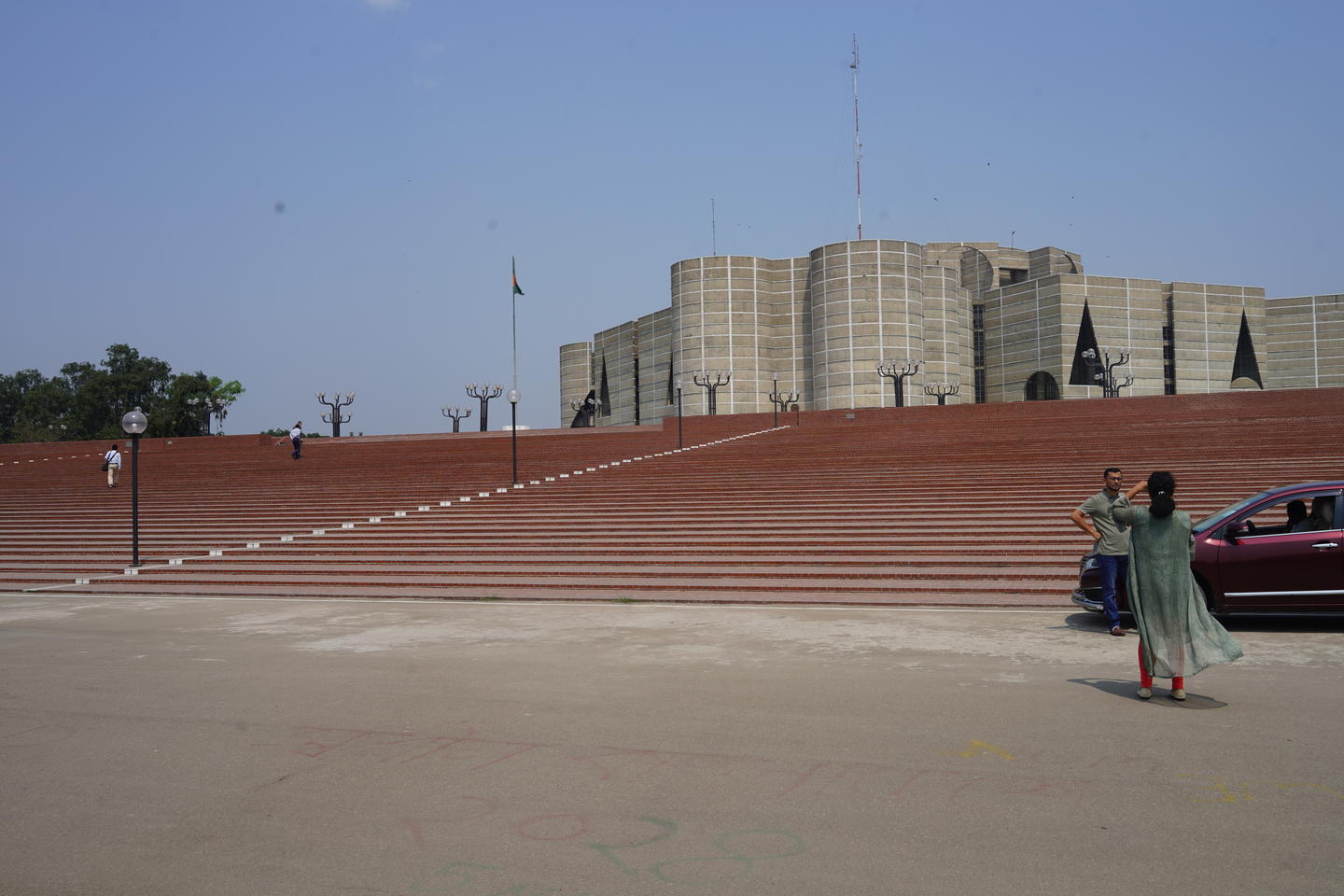 View of the red-edged wide-staired external entrance to the National Assembly Building in Dhaka.