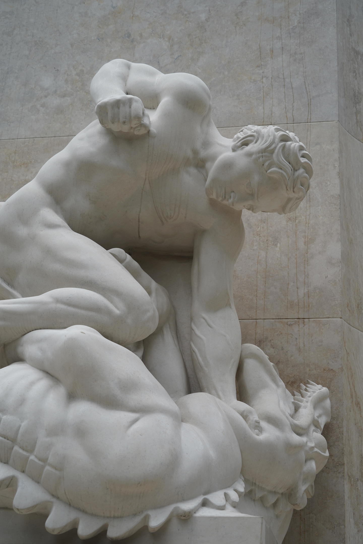 White Marble statue of a muscular man wrestling wirh a dragon, representative of Budapest's struggle with communism in Budapest